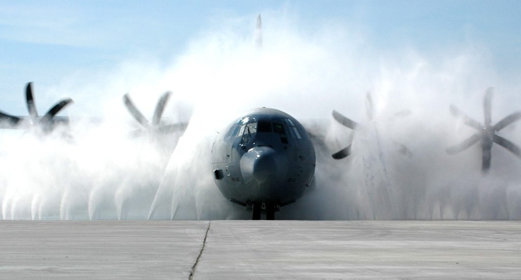 A C-130J Hercules is cleaned up in the new wash system at Keesler Air Force Base, Miss. Aircraft from the Air Force Reserve Command's 403rd Wing fly many hours over the Gulf of Mexico. Salt and moisture could lead to corrosion if aircraft are not kept clean. The new wash blasts aircraft with 2,000 gallons of water per minute, emitting 150 pounds of pressure from each of its 40 nozzles. (U.S. Air Force photo/Tech Sgt. Jame Pritchett)