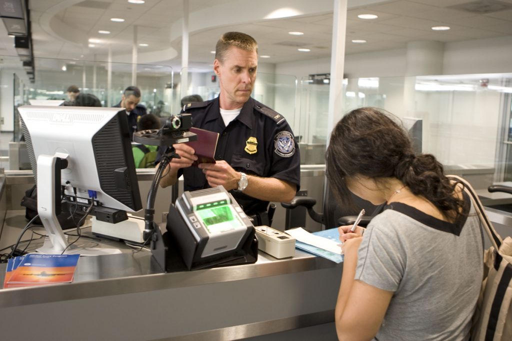 CBP Officer processes a passenger into the United States at an airport.