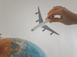 close up shot of a person holding an airplane toy