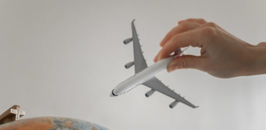 close up shot of a person holding an airplane toy